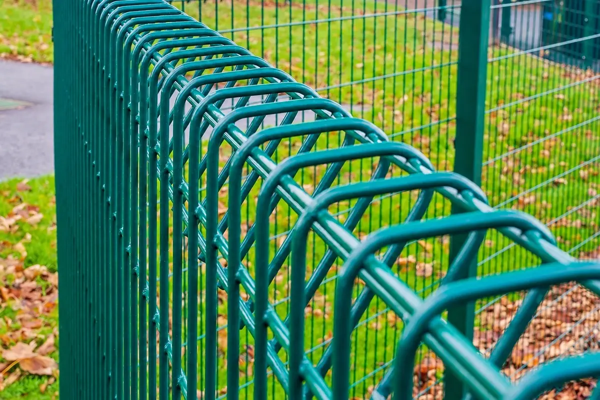 Close view of the wires and formed edge of a green welded mesh panel