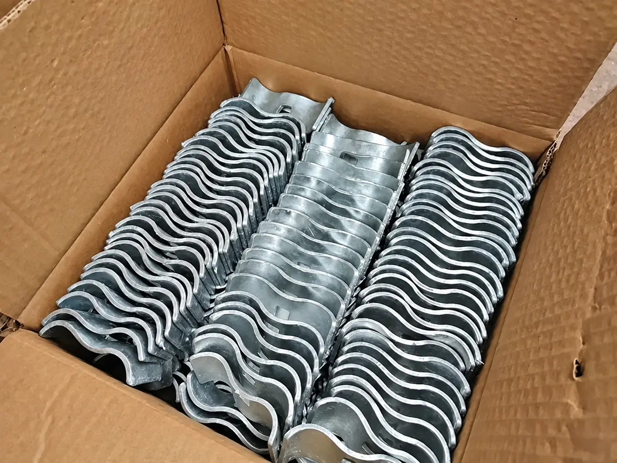 Fence clamps and fasteners arranged inside a carton