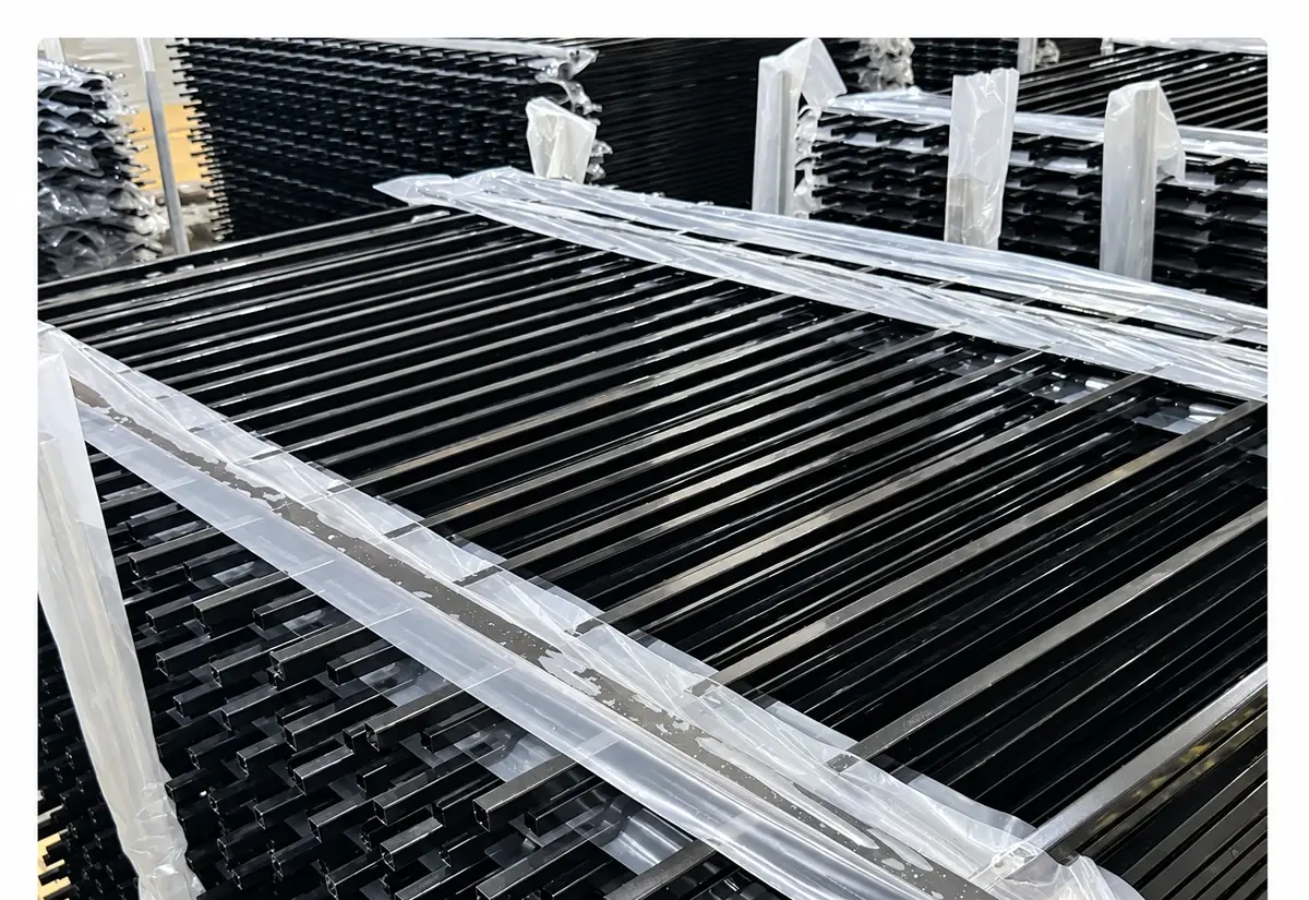 Wrapped black fence panels stacked on a pallet