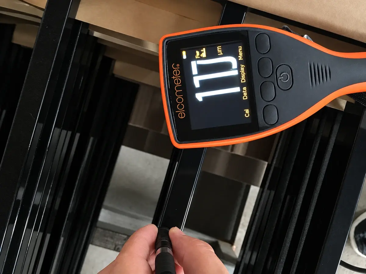 Coating thickness check on a black metal fence component