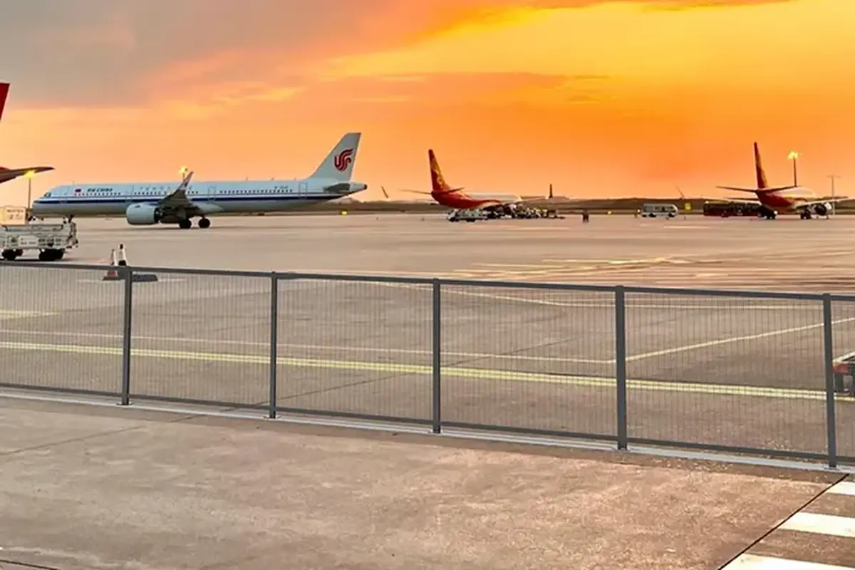 An installed security mesh fence defining an airport perimeter