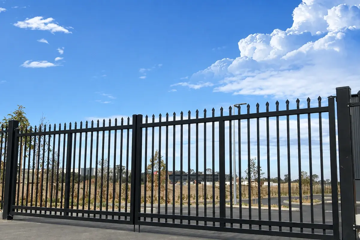 A double-leaf steel vehicle gate installed across an entrance