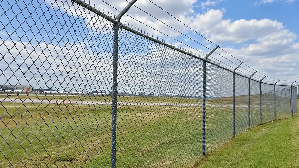 Diamond chain link mesh along an airport boundary
