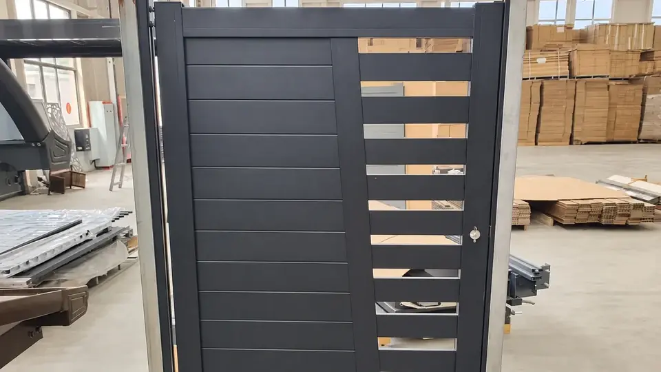 Assembled aluminum slat gate in a workshop