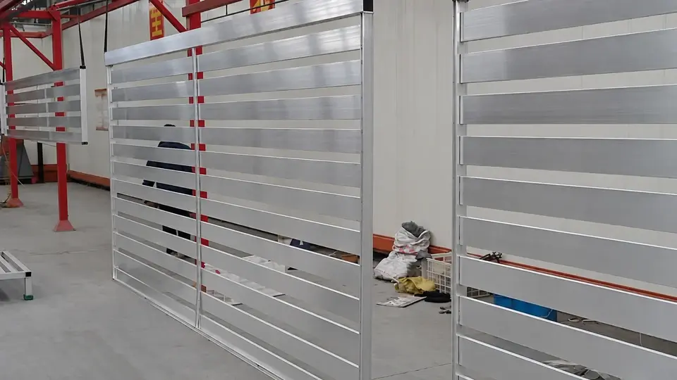 Aluminum slat panels hanging on a production line