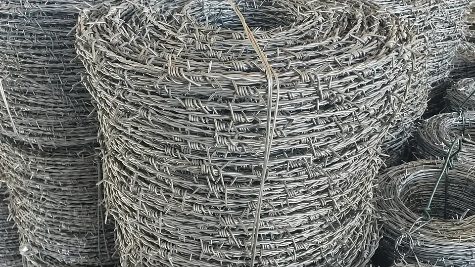 Coils of galvanized barbed wire stacked for storage