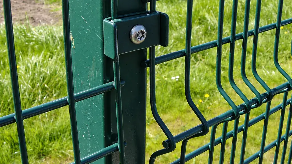 Bolted clip securing a welded mesh panel to a post