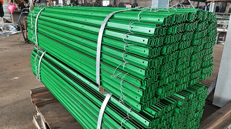 Bundled green steel Y posts in a workshop
