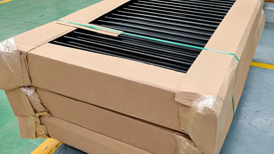 Packed black metal panels protected with cardboard corner pieces