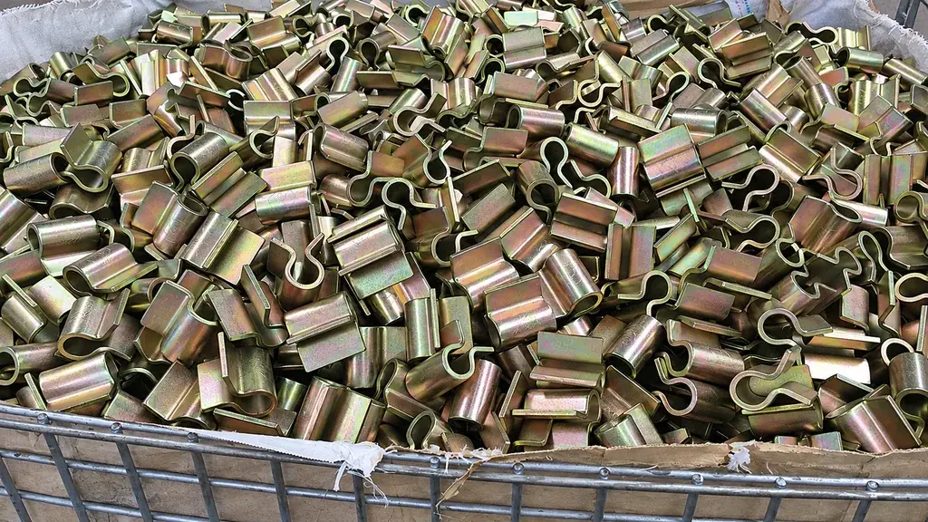 Metal fence brackets stored in a wire basket