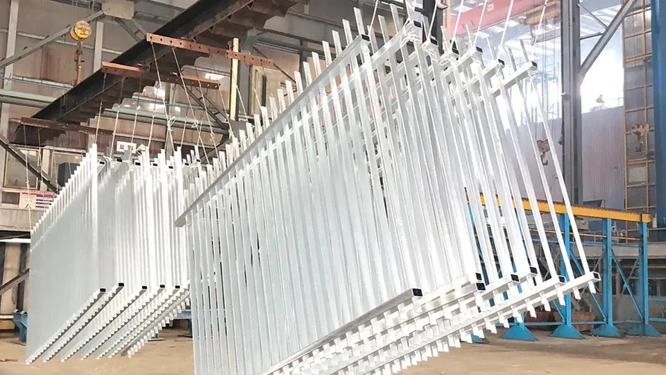 Metal fence panels suspended after hot dip galvanizing