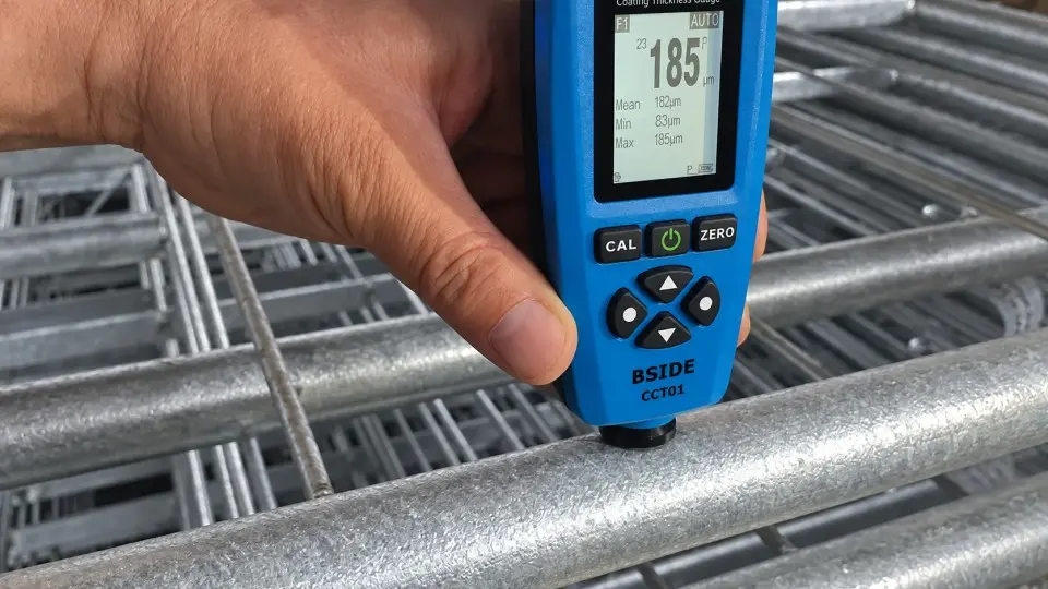 Handheld gauge measuring the coating on a galvanized tube