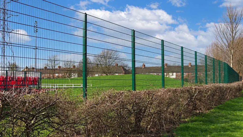Green welded mesh fencing beside electrical infrastructure