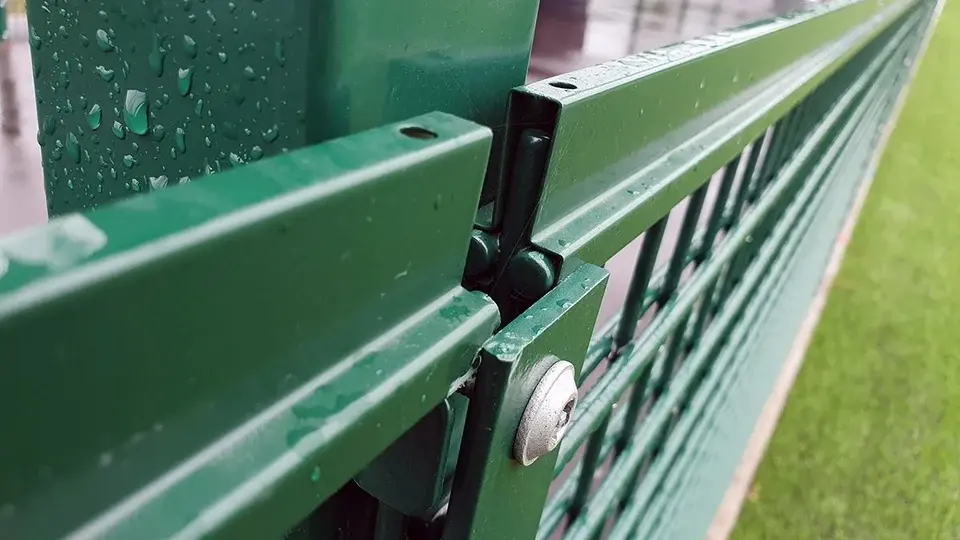 Close view of a green playground gate connection