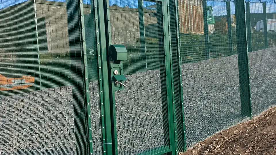 Green security gate with lock and wire mesh infill