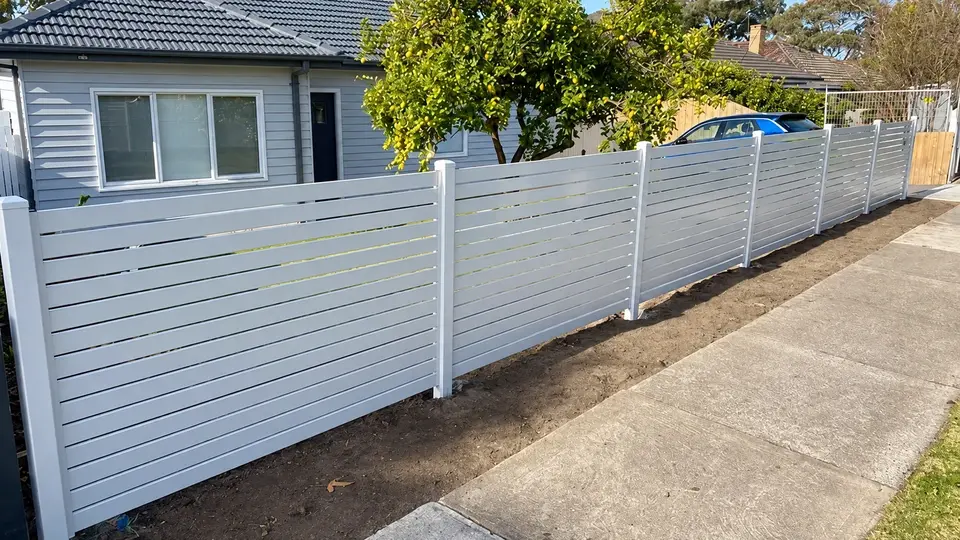 Light colored coated slat panels along a residential boundary