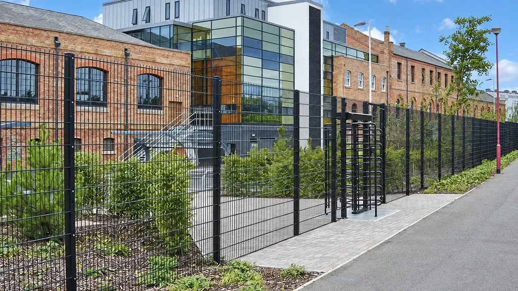 Mesh fencing separating a parking area from a pavement