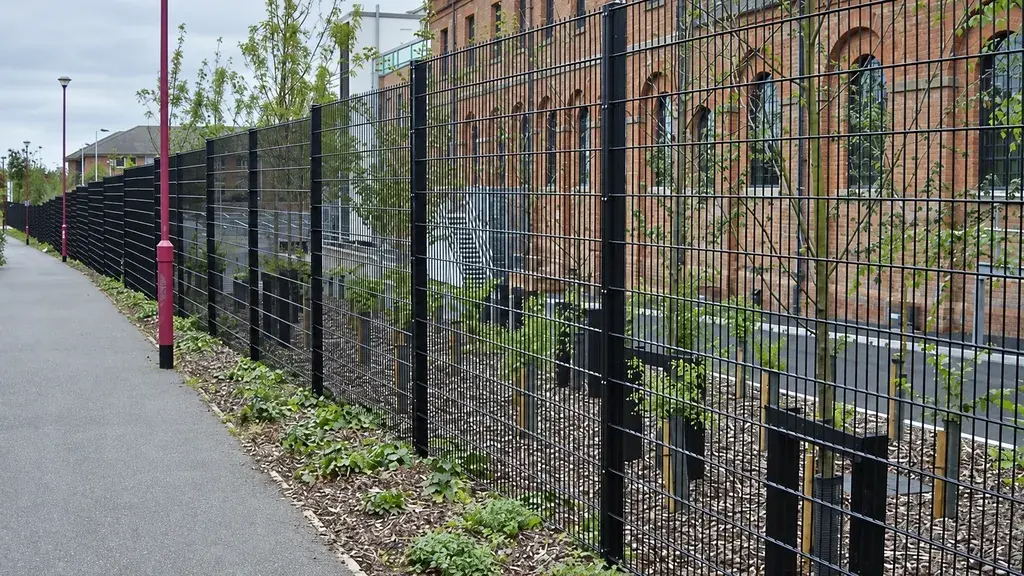 Repeated mesh panels along a brick building boundary