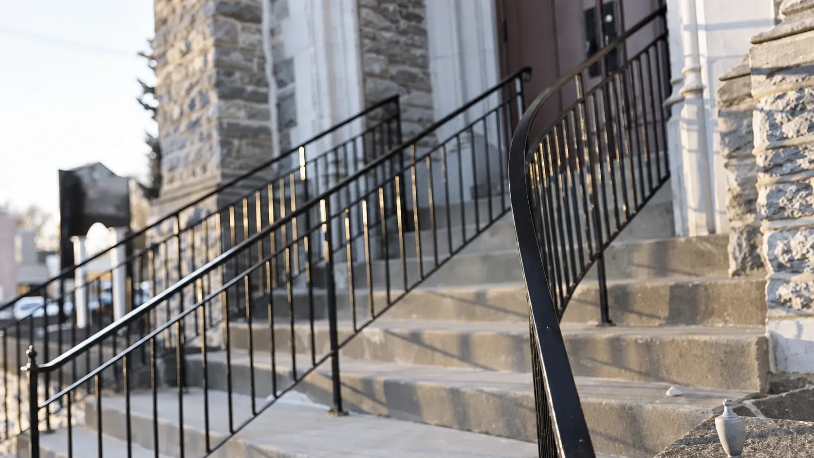 Metal handrails and fencing beside historic stone steps