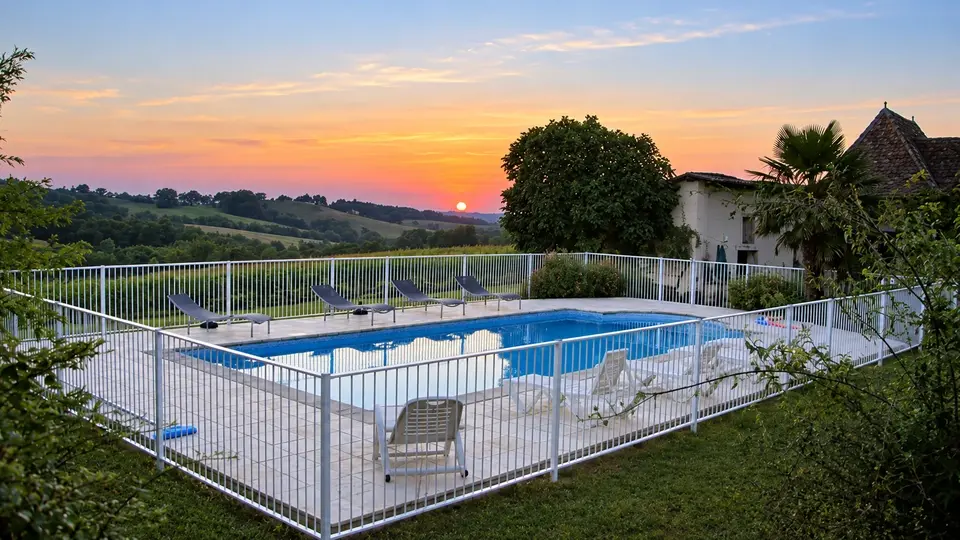 Metal safety fence around an outdoor swimming pool