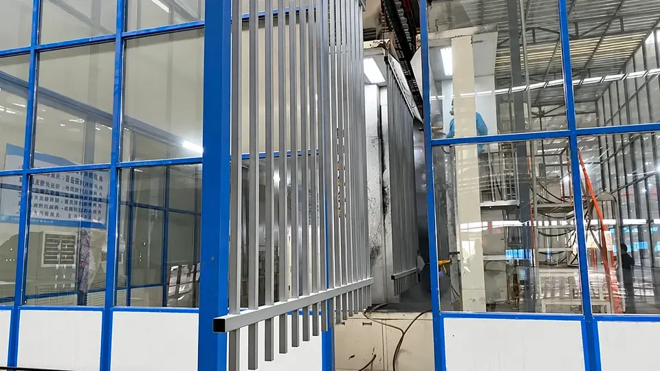 Metal railing panel hanging beside a coating booth