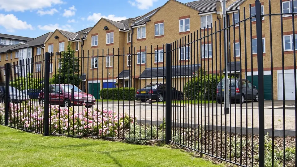 Vertical bar railings beside a residential lawn