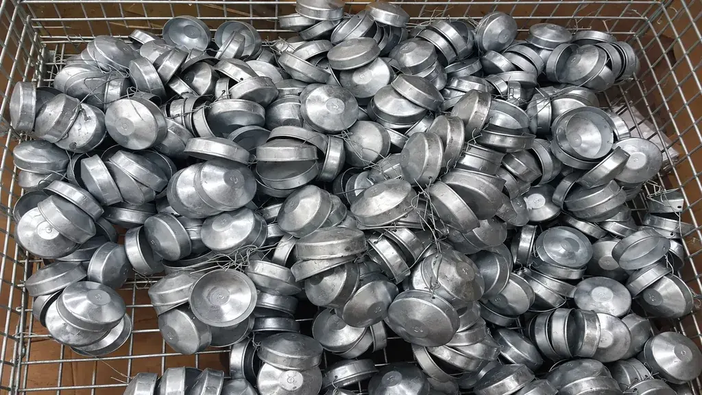 Galvanized round post caps in a storage basket