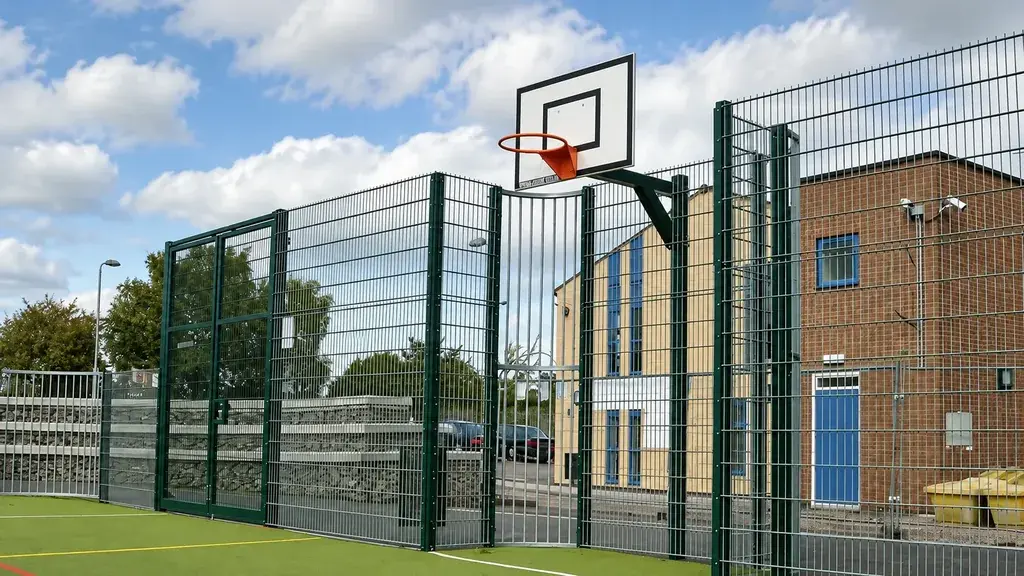 Mesh goal recess and basketball backboard at a school court