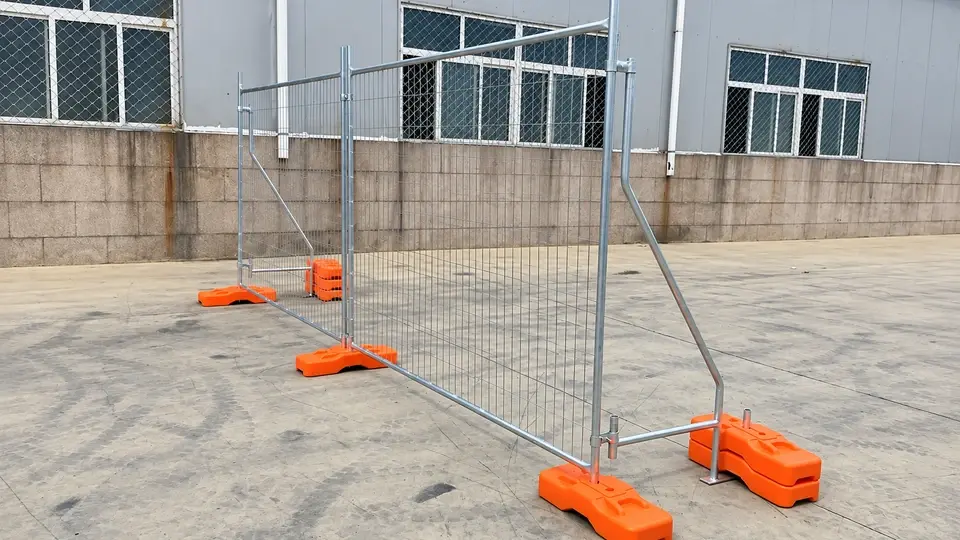 Temporary mesh fence with an angled brace and orange support bases