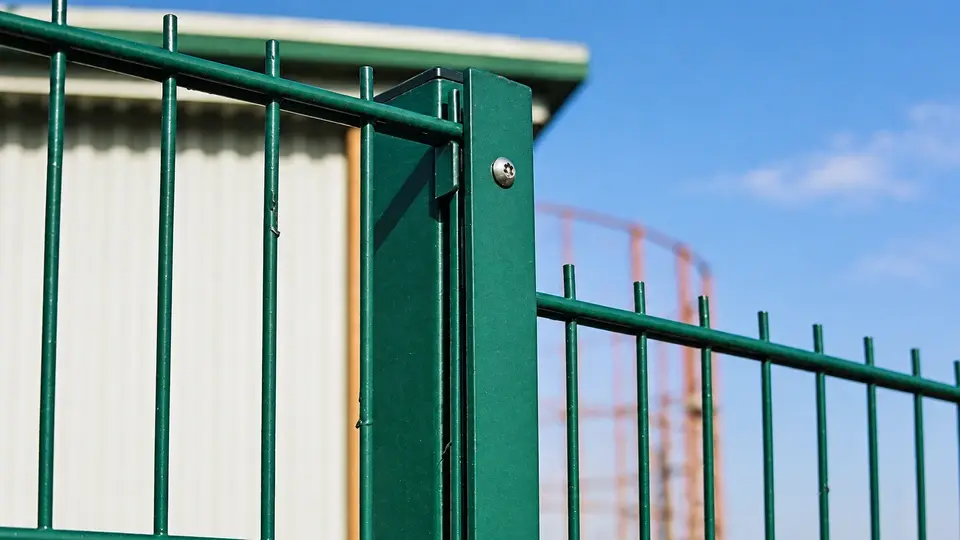 Twin horizontal wires at the edge of a green mesh panel