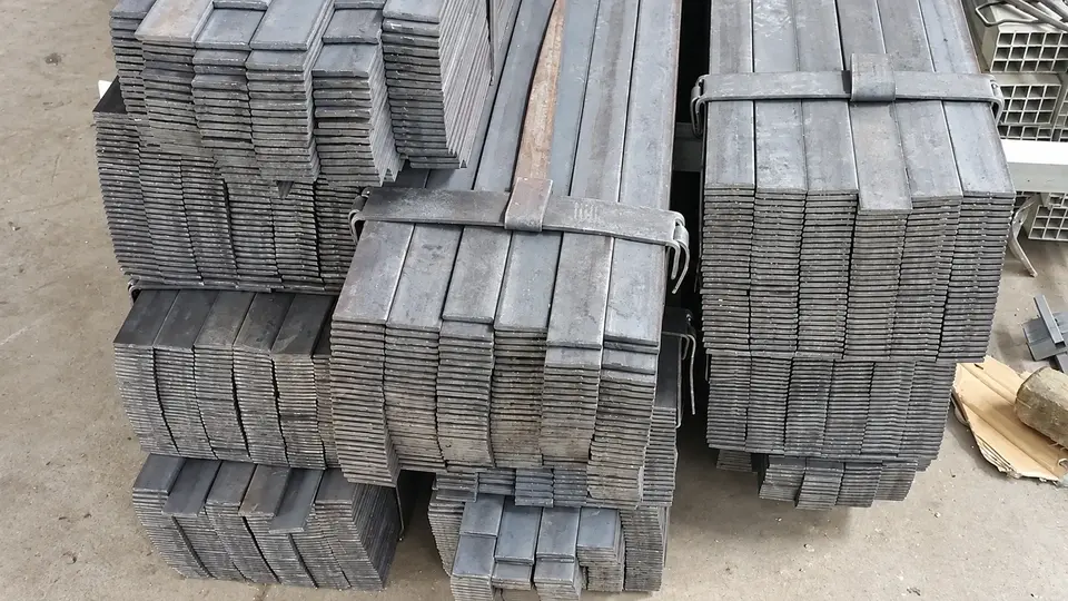 Bundles of unfinished steel sections in a workshop