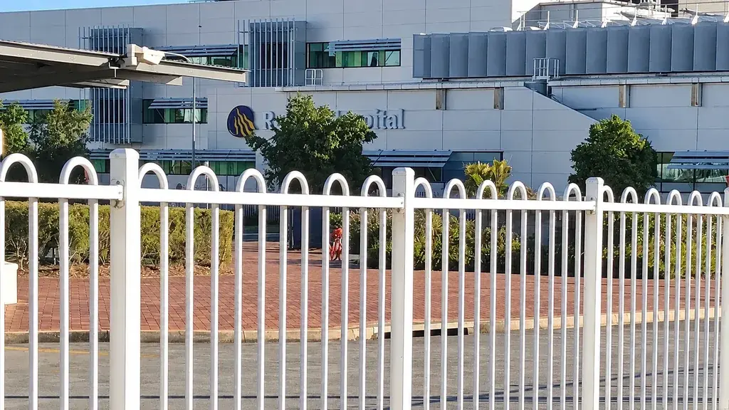 White bow top fence beside a hospital building