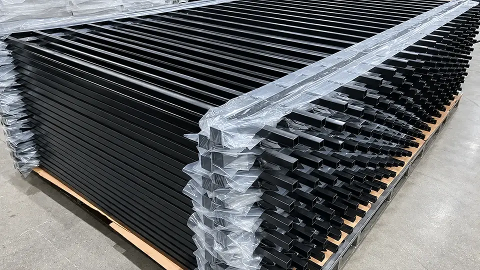 Protective wrapping around stacked black railing panels