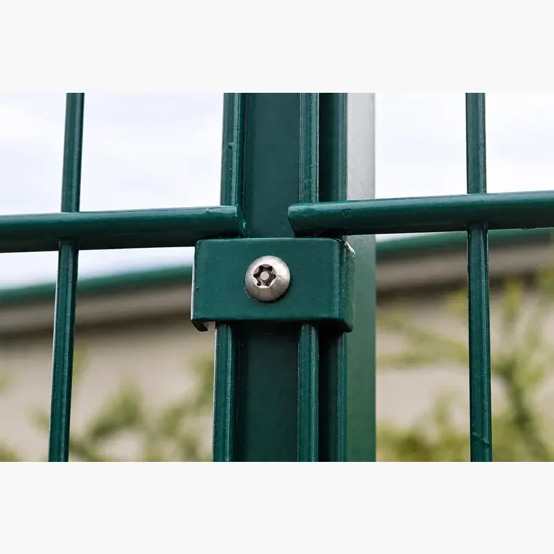 Close view of a recessed security-head screw holding a green mesh clip to a post