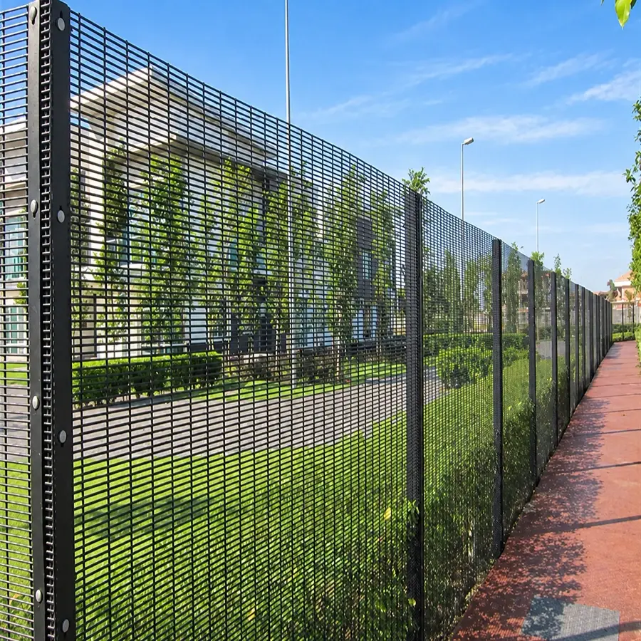 Black close-spaced welded mesh fence beside a paved path