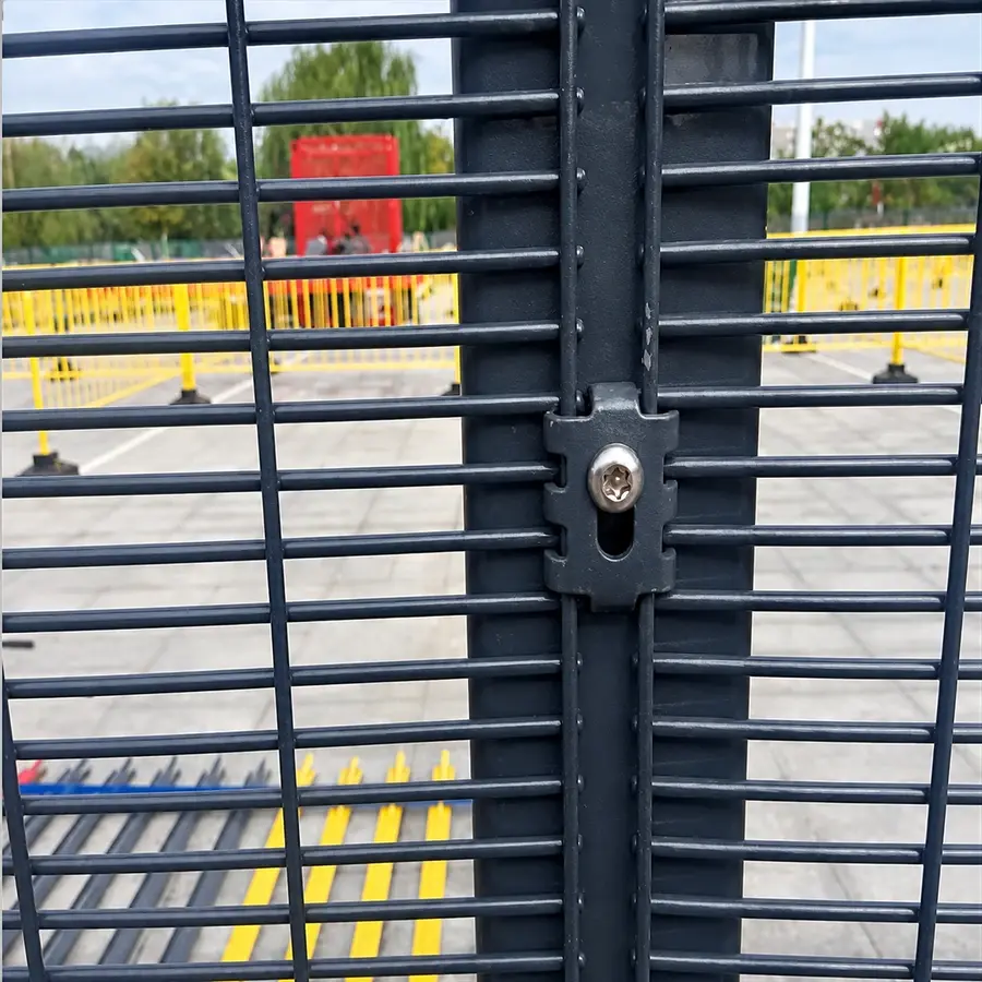 Individual black clamp fastening close-spaced mesh to a post