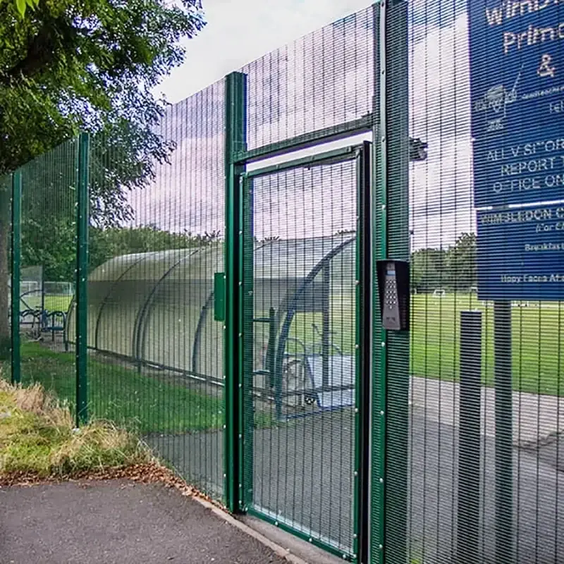 Green 358 mesh pedestrian gate beside matching fence panels