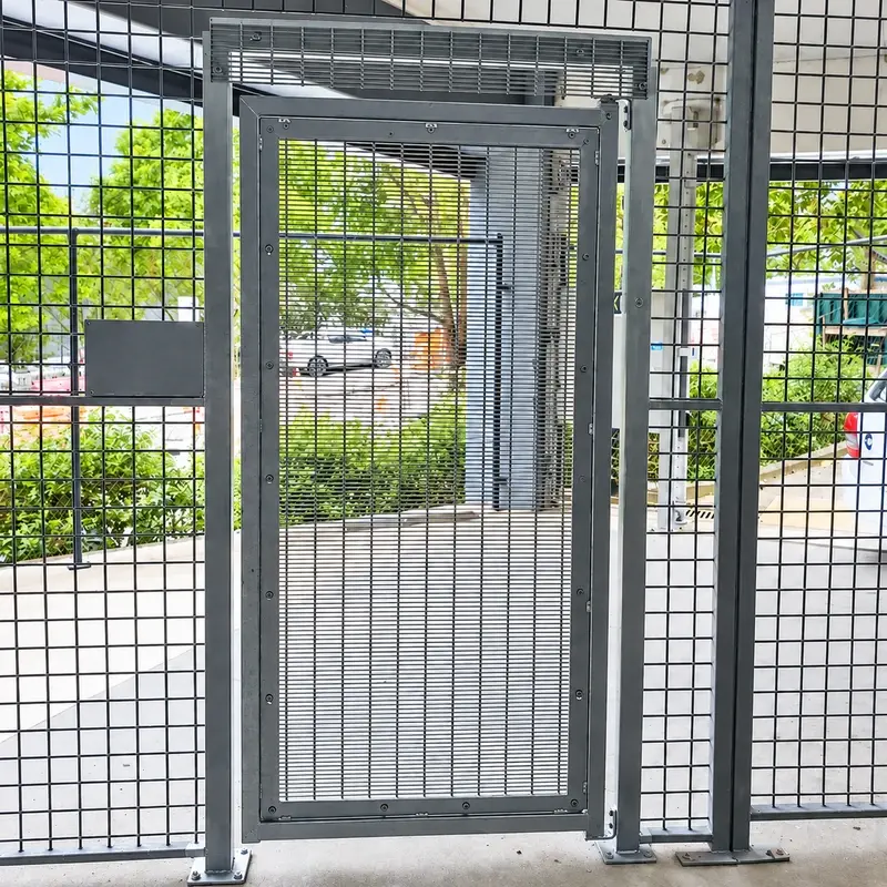358 mesh pedestrian gate open within a fenced entrance