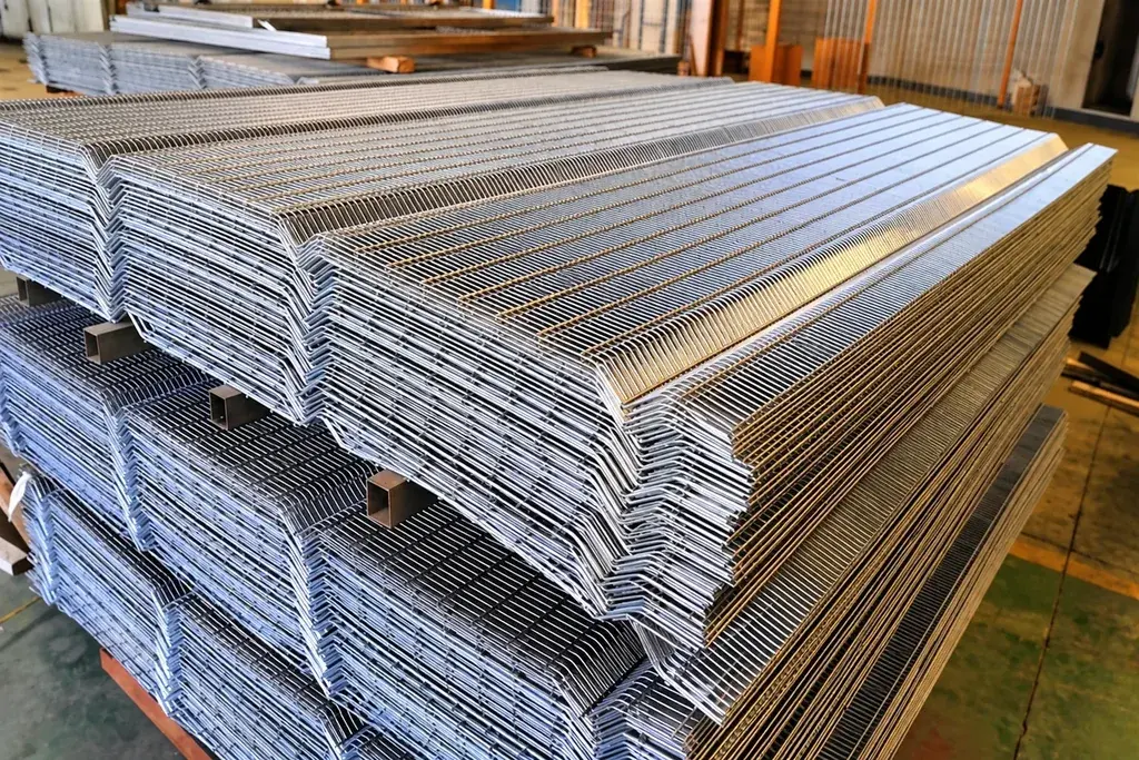 Stacked silver-coloured mesh panels showing nested V-bends