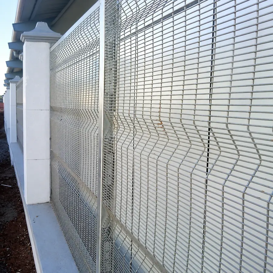 White close-spaced welded mesh with formed bends beside concrete posts