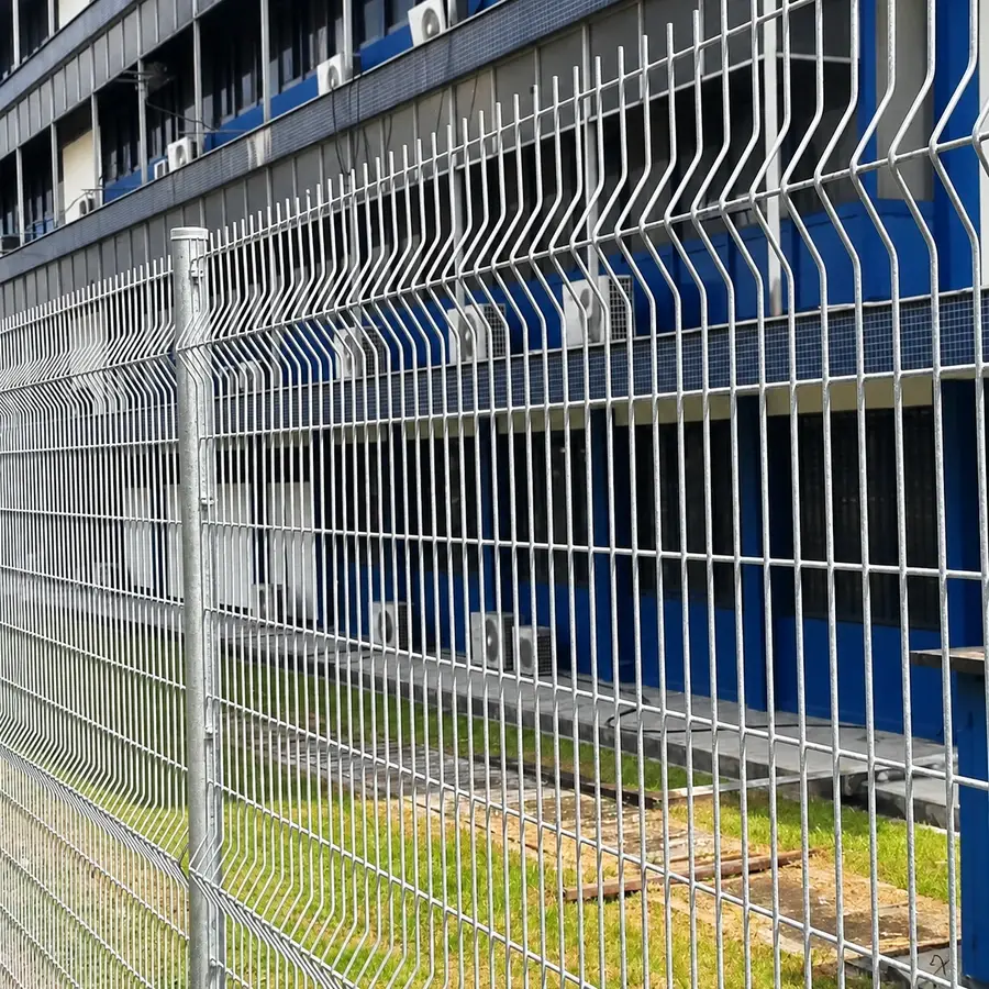 Silver-coloured folded mesh fence beside a building