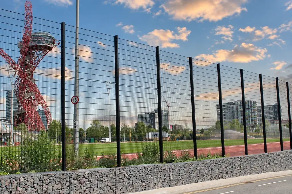 Dark 868 twin-wire fence panels and posts along a site boundary