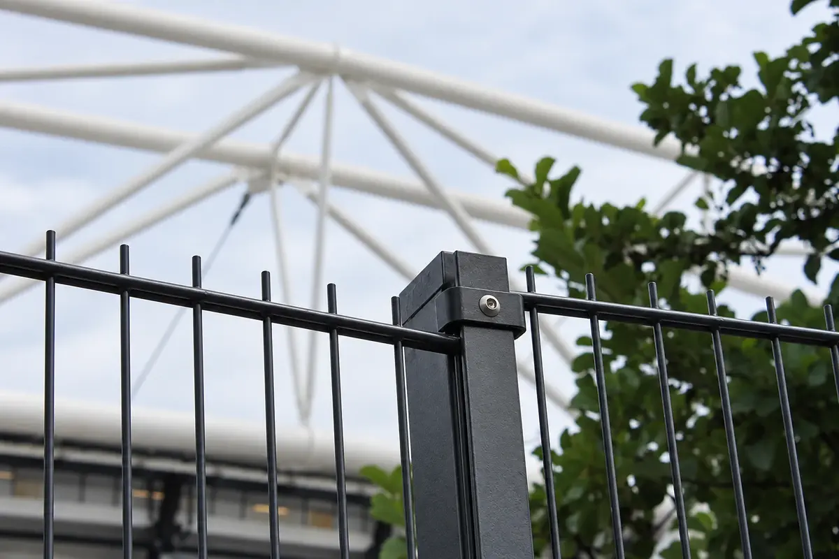 Close view of twin-wire fence panels meeting a square post