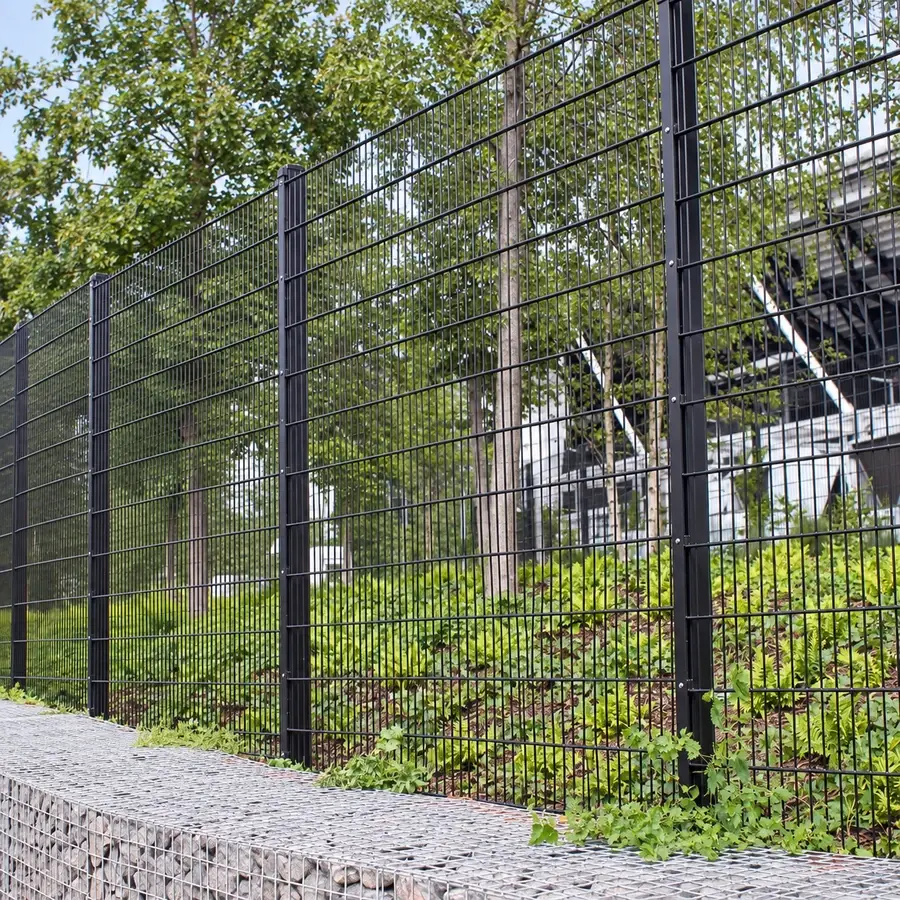 Tall double-wire panels beside a planted boundary