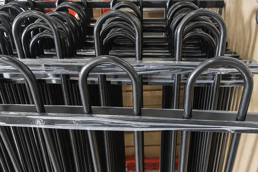 Bundled metal bow-top railing panels held together with straps