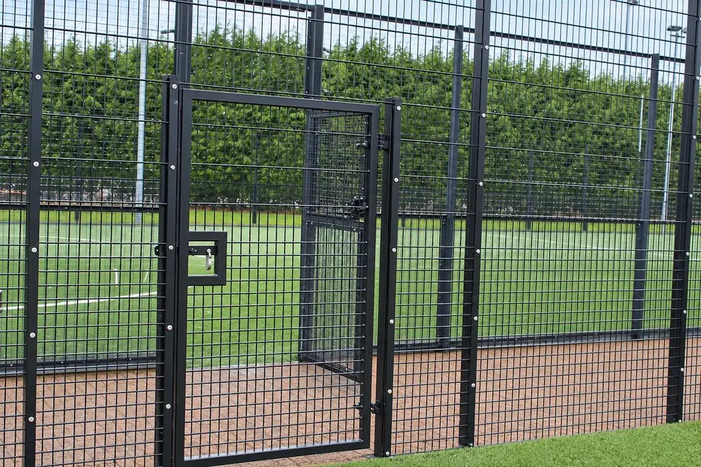 Black mesh pedestrian gate with matching fence panels and posts