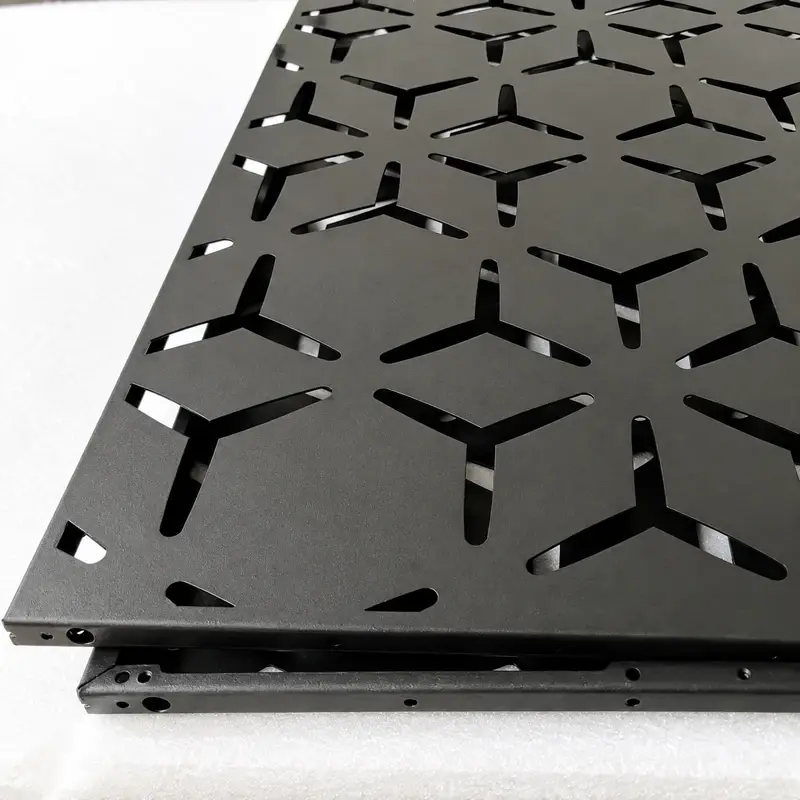 Dark laser-cut metal panels with geometric openings and fixing holes