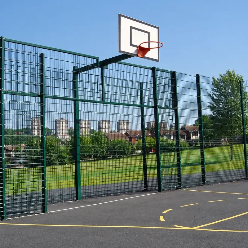 Tall sports court enclosure with basketball hoop