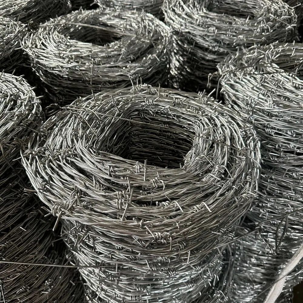 Several coils of galvanised barbed wire stacked together