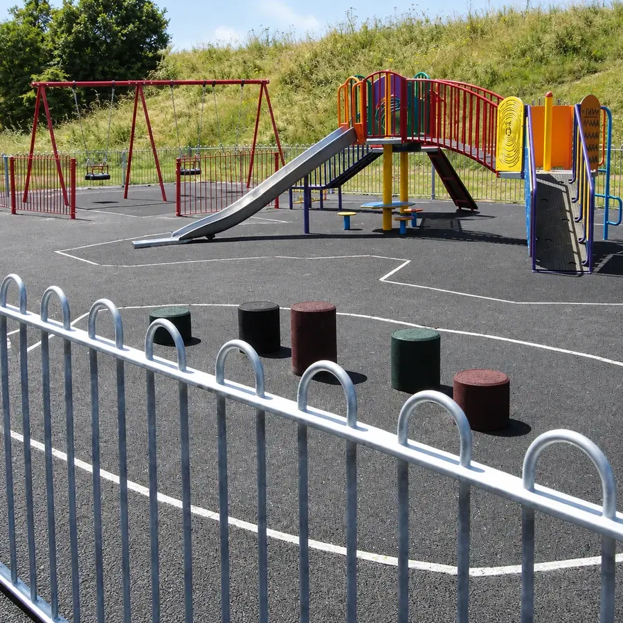 Silver bow top railing around an outdoor play area